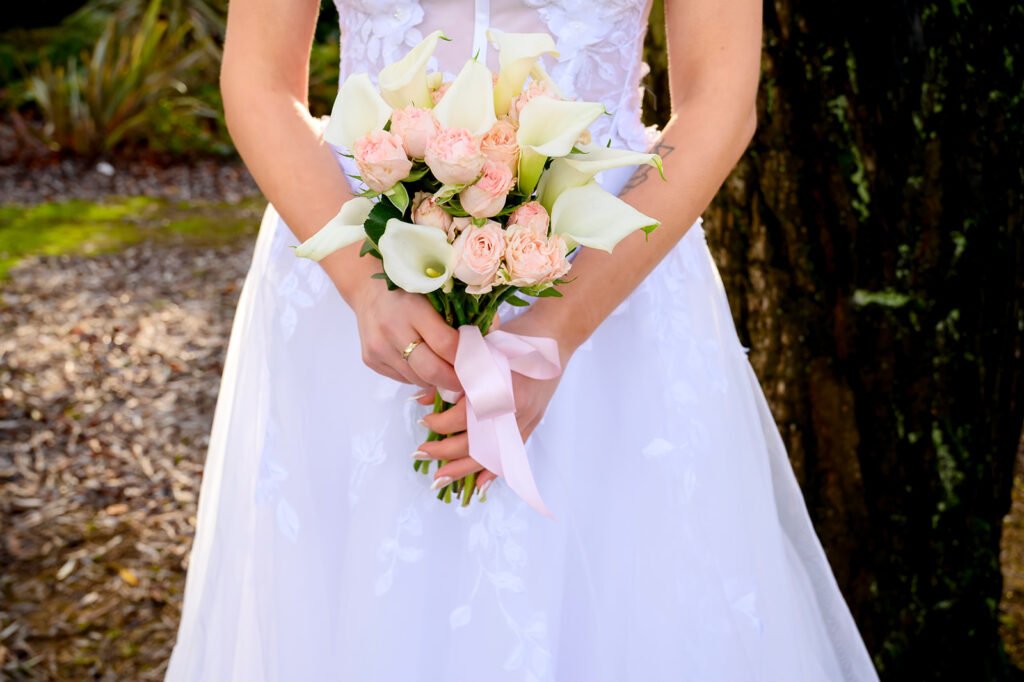 Bride in a white wedding dress posing in the gardens near Sandwell Register Office.